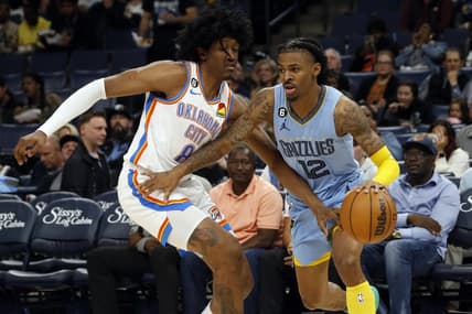 Dec 7, 2022; Memphis, Tennessee, USA; Memphis Grizzlies guard Ja Morant (12) dribbles as Oklahoma City Thunder forward Jalen Williams (8) defends during the second half at FedExForum. Mandatory Credit: Petre Thomas-USA TODAY Sports
