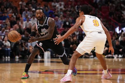 Dec 8, 2022; Miami, Florida, USA; LA Clippers guard John Wall (11) passes the ball away from Miami Heat guard Dru Smith (9) during the first half at FTX Arena. Mandatory Credit: Jasen Vinlove-USA TODAY Sports