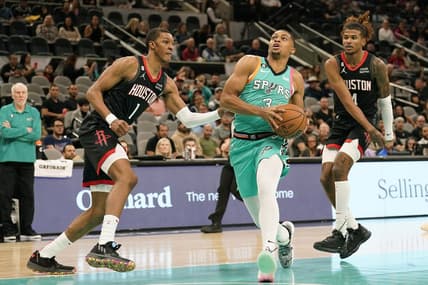 Dec 8, 2022; San Antonio, Texas, USA; San Antonio Spurs forward Keldon Johnson (3) drives to the basket past Houston Rockets forward Jabari Smith Jr. (1) and guard Jalen Green (4) during the first half at AT&T Center. Mandatory Credit: Scott Wachter-USA TODAY Sports