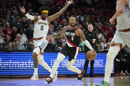 Dec 8, 2022; Portland, Oregon, USA; Portland Trail Blazers guard Damian Lillard (0) drives to the basket during the first half against Denver Nuggets guard Kentavious Caldwell-Pope (5) at Moda Center. Mandatory Credit: Troy Wayrynen-USA TODAY Sports