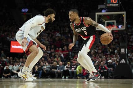 Dec 8, 2022; Portland, Oregon, USA; Denver Nuggets guard Jamal Murray (27) defends Portland Trail Blazers guard Damian Lillard (0) during the first half at Moda Center. Mandatory Credit: Troy Wayrynen-USA TODAY Sports