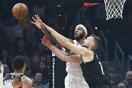 Dec 9, 2022; Cleveland, Ohio, USA; Cleveland Cavaliers forward Lamar Stevens (8) and Sacramento Kings forward Domantas Sabonis (10) go for a rebound during the first half at Rocket Mortgage FieldHouse. Mandatory Credit: Ken Blaze-USA TODAY Sports