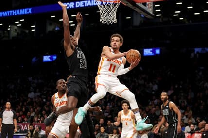 Dec 9, 2022; Brooklyn, New York, USA; Atlanta Hawks guard Trae Young (11) looks to pass the ball around Brooklyn Nets center Day'Ron Sharpe (20) during the second quarter at Barclays Center. Mandatory Credit: Brad Penner-USA TODAY Sports