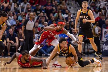 Dec 9, 2022; New Orleans, Louisiana, USA; Phoenix Suns guard Devin Booker (1) and New Orleans Pelicans forward Naji Marshall (8) fight for a loose ball on the court during the first half at Smoothie King Center. Mandatory Credit: Stephen Lew-USA TODAY Sports