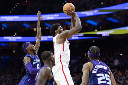 Dec 11, 2022; Philadelphia, Pennsylvania, USA; Philadelphia 76ers center Joel Embiid (21) shoots the ball past Charlotte Hornets forward Jalen McDaniels (6) and forward P.J. Washington (25) and guard Terry Rozier (3) during the fourth quarter at Wells Fargo Center. Mandatory Credit: Bill Streicher-USA TODAY Sports