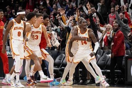 Dec 11, 2022; Atlanta, Georgia, USA; Atlanta Hawks forward AJ Griffin (14) reacts with teammates after making a shot at the buzzer to defeat the Chicago Bulls in overtime at State Farm Arena. Mandatory Credit: Dale Zanine-USA TODAY Sports