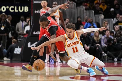 Dec 11, 2022; Atlanta, Georgia, USA; Chicago Bulls forward Javonte Green (24) and Atlanta Hawks guard Trae Young (11) fight for the ball on the floor during the second half at State Farm Arena. Mandatory Credit: Dale Zanine-USA TODAY Sports