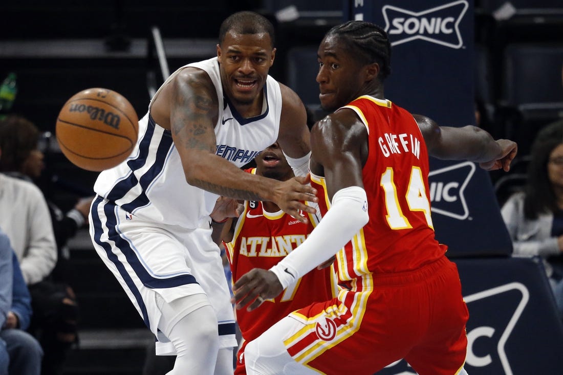 Dec 12, 2022; Memphis, Tennessee, USA; Memphis Grizzlies forward Xavier Tillman (left) and Atlanta Hawks forward AJ Griffin (14) battle for a a loose ball during the first half at FedExForum. Mandatory Credit: Petre Thomas-USA TODAY Sports
