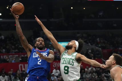 Dec 12, 2022; Los Angeles, California, USA; LA Clippers forward Kawhi Leonard (2) shoots the ball against Boston Celtics guard Derrick White (9) and forward Blake Griffin (91) in the second half at Crypto.com Arena. The Clippers defeated the Celtics 113-93. Mandatory Credit: Kirby Lee-USA TODAY Sports