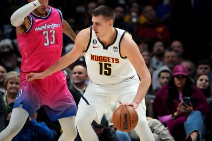 Dec 14, 2022; Denver, Colorado, USA; Denver Nuggets center Nikola Jokic (15) dribbles from Washington Wizards forward Kyle Kuzma (33) in the second quarter at Ball Arena. Mandatory Credit: Ron Chenoy-USA TODAY Sports