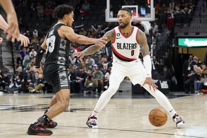 Dec 14, 2022; San Antonio, Texas, USA; Portland Trailblazers guard Damian Lillard (0) looks to the pass the ball while defended by San Antonio Spurs guard Tre Jones (33) during the second half at AT&T Center. Mandatory Credit: Scott Wachter-USA TODAY Sports