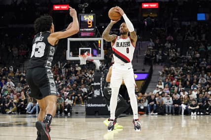 Dec 14, 2022; San Antonio, Texas, USA; Portland Trail Blazers guard Damian Lillard (0) shoots over San Antonio Spurs guard Tre Jones (33) during the second half at AT&T Center. Mandatory Credit: Scott Wachter-USA TODAY Sports