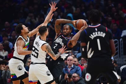 Dec 14, 2022; Los Angeles, California, USA; Los Angeles Clippers forward Kawhi Leonard (2) controls the ball against Minnesota Timberwolves guard Bryn Forbes (10) and guard Austin Rivers (25) during the first half at Crypto.com Arena. Mandatory Credit: Gary A. Vasquez-USA TODAY Sports