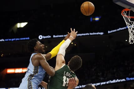 Dec 15, 2022; Memphis, Tennessee, USA; Memphis Grizzlies forward Jaren Jackson Jr. (13) shoots as Milwaukee Bucks center Brook Lopez (11) defends during the first half at FedExForum. Mandatory Credit: Petre Thomas-USA TODAY Sports
