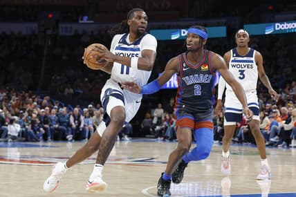Dec 16, 2022; Oklahoma City, Oklahoma, USA; Minnesota Timberwolves center Naz Reid (11) drives to the basket against Oklahoma City Thunder guard Shai Gilgeous-Alexander (2) during the first quarter at Paycom Center. Mandatory Credit: Alonzo Adams-USA TODAY Sports