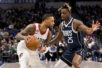 Dec 16, 2022; Dallas, Texas, USA; Portland Trail Blazers guard Damian Lillard (0) looks to dribble past Dallas Mavericks forward Reggie Bullock (25) during the second quarter at the American Airlines Center. Mandatory Credit: Jerome Miron-USA TODAY Sports