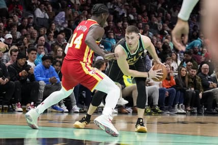Dec 16, 2022; Charlotte, North Carolina, USA; Charlotte Hornets forward Gordon Hayward (20) looks to make a break from Atlanta Hawks forward AJ Griffin (14) during the second half at Spectrum Center. Mandatory Credit: Jim Dedmon-USA TODAY Sports