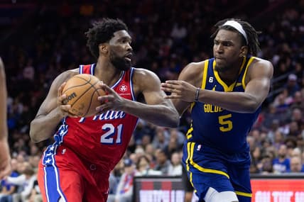 Dec 16, 2022; Philadelphia, Pennsylvania, USA; Philadelphia 76ers center Joel Embiid (21) drives against Golden State Warriors center Kevon Looney (5) during the fourth quarter at Wells Fargo Center. Mandatory Credit: Bill Streicher-USA TODAY Sports