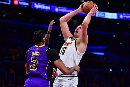 Dec 16, 2022; Los Angeles, California, USA; Denver Nuggets center Nikola Jokic (15) shoots against Los Angeles Lakers forward Anthony Davis (3)  during the first half at Crypto.com Arena. Mandatory Credit: Gary A. Vasquez-USA TODAY Sports