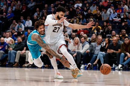 Dec 18, 2022; Denver, Colorado, USA; Charlotte Hornets guard Kelly Oubre Jr. (12) knocks the ball away from Denver Nuggets guard Jamal Murray (27) in the fourth quarter at Ball Arena. Mandatory Credit: Isaiah J. Downing-USA TODAY Sports
