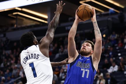 Dec 19, 2022; Minneapolis, Minnesota, USA; Dallas Mavericks guard Luka Doncic (77) shoots while Minnesota Timberwolves guard Anthony Edwards (1) defends during the first quarter at Target Center. Mandatory Credit: Matt Krohn-USA TODAY Sports