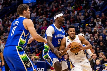 Dec 19, 2022; New Orleans, Louisiana, USA; New Orleans Pelicans guard CJ McCollum (3) dribbles against Milwaukee Bucks forward Bobby Portis (9) and center Brook Lopez (11) during the first half at Smoothie King Center. Mandatory Credit: Stephen Lew-USA TODAY Sports