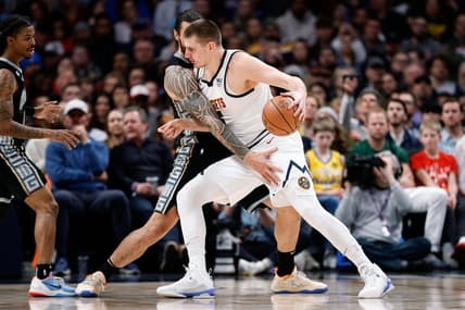 Dec 20, 2022; Denver, Colorado, USA; Denver Nuggets center Nikola Jokic (15) controls the ball as Memphis Grizzlies center Steven Adams (4) guards in the first quarter at Ball Arena. Mandatory Credit: Isaiah J. Downing-USA TODAY Sports