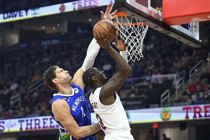 Dec 21, 2022; Cleveland, Ohio, USA; Milwaukee Bucks center Brook Lopez (11) defends a shot by Cleveland Cavaliers guard Caris LeVert (3) in the second quarter at Rocket Mortgage FieldHouse. Mandatory Credit: David Richard-USA TODAY Sports