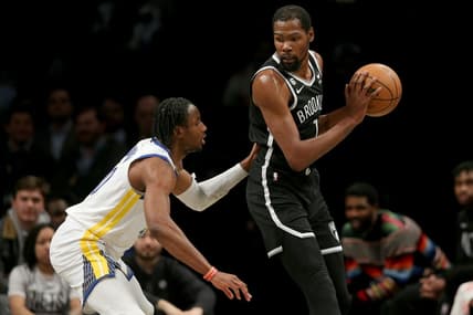 Dec 21, 2022; Brooklyn, New York, USA; Brooklyn Nets forward Kevin Durant (7) controls the ball against Golden State Warriors forward Jonathan Kuminga (00) during the first quarter at Barclays Center. Mandatory Credit: Brad Penner-USA TODAY Sports