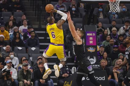 Dec 21, 2022; Sacramento, California, USA; Los Angeles Lakers forward LeBron James (6) shoots the ball over Sacramento Kings forward Domantas Sabonis (10) during the first quarter at Golden 1 Center. Mandatory Credit: Sergio Estrada-USA TODAY Sports