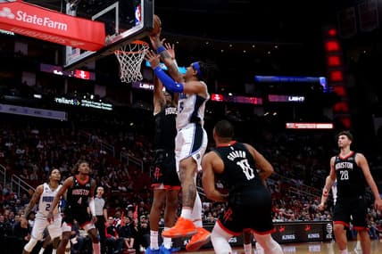 Dec 21, 2022; Houston, Texas, USA; Orlando Magic forward Paolo Banchero (5) makes a layup while Houston Rockets forward Jabari Smith Jr. (1) defends during the fourth quarter at Toyota Center. Mandatory Credit: Erik Williams-USA TODAY Sports
