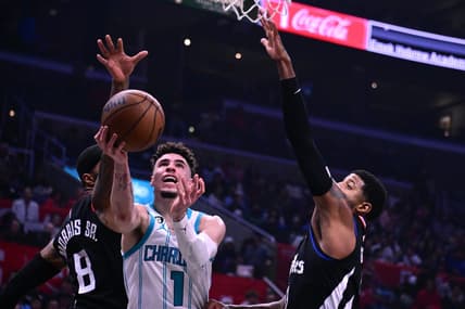 Dec 21, 2022; Los Angeles, California, USA; Charlotte Hornets guard LaMelo Ball (1) goes to the basket past Los Angeles Clippers forward Marcus Morris (8) during the second quarter at Crypto.com Arena. Mandatory Credit: Richard Mackson-USA TODAY Sports