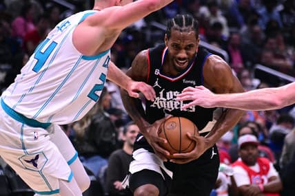 Dec 21, 2022; Los Angeles, California, USA; Los Angeles Clippers forward Kawhi Leonard (2) goes to the basket while defended by Charlotte Hornets center Mason Plumlee (24) during the third quarter at Crypto.com Arena. Mandatory Credit: Richard Mackson-USA TODAY Sports