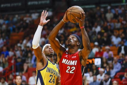 Dec 23, 2022; Miami, Florida, USA; Miami Heat forward Jimmy Butler (22) protects the ball from Indiana Pacers guard Buddy Hield (24) during the first quarter at FTX Arena. Mandatory Credit: Sam Navarro-USA TODAY Sports