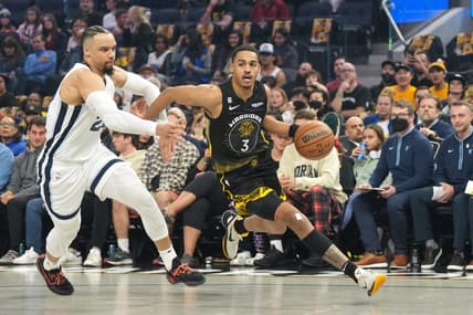 Dec 25, 2022; San Francisco, California, USA; Golden State Warriors guard Jordan Poole (3) dribbles against Memphis Grizzlies forward Dillon Brooks (24) during the first quarter at Chase Center. Mandatory Credit: Darren Yamashita-USA TODAY Sports