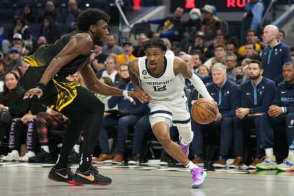 Dec 25, 2022; San Francisco, California, USA; Memphis Grizzlies guard Ja Morant (12) dribbles against Golden State Warriors center James Wiseman (33) during the third quarter at Chase Center. Mandatory Credit: Darren Yamashita-USA TODAY Sports