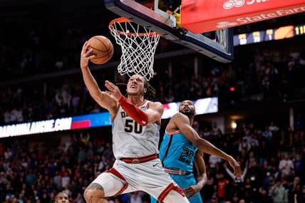Dec 25, 2022; Denver, Colorado, USA; Denver Nuggets forward Aaron Gordon (50) drives to the net against Phoenix Suns forward Mikal Bridges (25) in overtime at Ball Arena. Mandatory Credit: Isaiah J. Downing-USA TODAY Sports