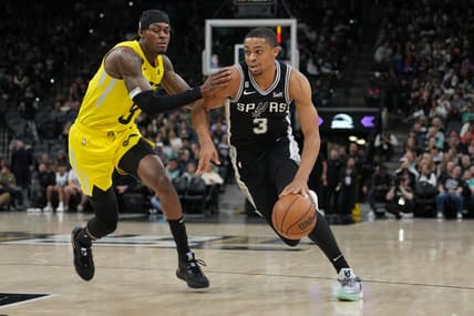 Dec 26, 2022; San Antonio, Texas, USA;  San Antonio Spurs forward Keldon Johnson (3) dribbles past Utah Jazz forward Jarred Vanderbilt (8) in the first half at the AT&T Center. Mandatory Credit: Daniel Dunn-USA TODAY Sports