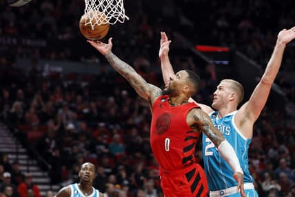 Dec 26, 2022; Portland, Oregon, USA; Portland Trail Blazers point guard Damian Lillard (0) shoots the ballast Charlotte Hornets center Mason Plumlee (24) during the first half at Moda Center. Mandatory Credit: Soobum Im-USA TODAY Sports
