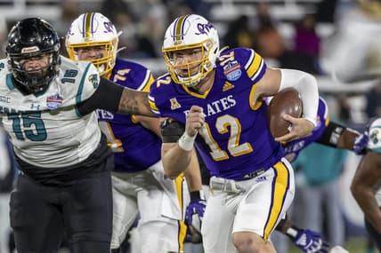 Dec 27, 2022; Birmingham, Alabama, USA; East Carolina Pirates quarterback Holton Ahlers (12) runs the ball against the Coastal Carolina Chanticleers in the 2022 Birmingham Bowl at Protective Stadium. Mandatory Credit: Vasha Hunt-USA TODAY Sports