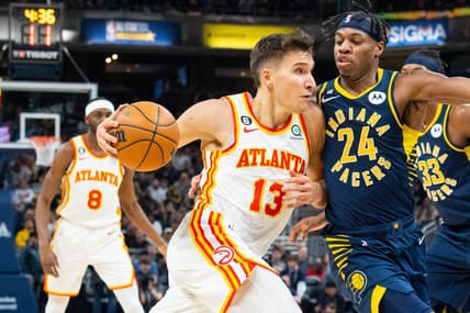 Dec 27, 2022; Indianapolis, Indiana, USA; Atlanta Hawks guard Bogdan Bogdanovic (13) dribbles the ball while Indiana Pacers guard Buddy Hield (24) defends in the first quarter at Gainbridge Fieldhouse. Mandatory Credit: Trevor Ruszkowski-USA TODAY Sports