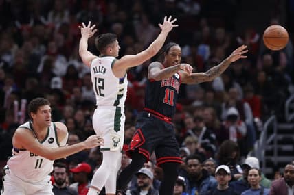 Dec 28, 2022; Chicago, Illinois, USA; Chicago Bulls forward DeMar DeRozan (11) passes the ball away from Milwaukee Bucks guard Grayson Allen (12) during the first half at United Center. Mandatory Credit: Kamil Krzaczynski-USA TODAY Sports