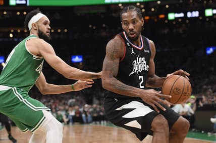 Dec 29, 2022; Boston, Massachusetts, USA;  LA Clippers forward Kawhi Leonard (2) controls the ball while Boston Celtics guard Derrick White (9) defends during the first half at TD Garden. Mandatory Credit: Bob DeChiara-USA TODAY Sports