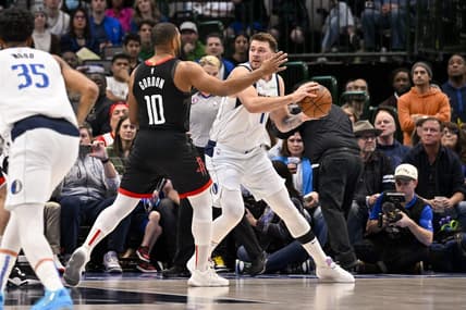 Dec 29, 2022; Dallas, Texas, USA; Dallas Mavericks guard Luka Doncic (77) looks to pass around Houston Rockets guard Eric Gordon (10) during the first quarter at the American Airlines Center. Mandatory Credit: Jerome Miron-USA TODAY Sports