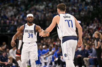 Dec 29, 2022; Dallas, Texas, USA; Dallas Mavericks guard Luka Doncic (77) greets guard Kemba Walker (34) as Walker enters the game against the Houston Rockets during the first half at the American Airlines Center. Mandatory Credit: Jerome Miron-USA TODAY Sports
