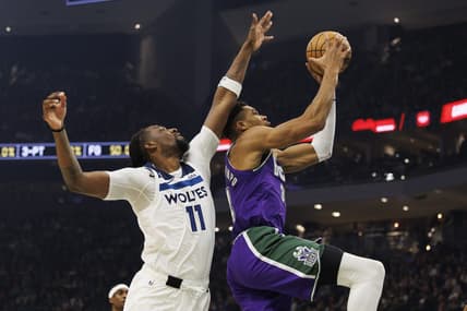 Dec 30, 2022; Milwaukee, Wisconsin, USA;  Milwaukee Bucks forward Giannis Antetokounmpo (34) shoots beyond the reach of Minnesota Timberwolves center Naz Reid (11) during the first quarter at Fiserv Forum. Mandatory Credit: Jeff Hanisch-USA TODAY Sports