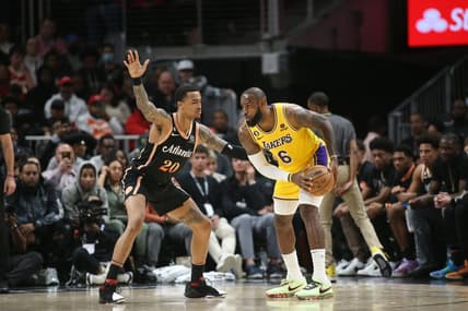 Dec 30, 2022; Atlanta, Georgia, USA; Atlanta Hawks forward John Collins (20) defends Los Angeles Lakers forward LeBron James (6) in the second quarter at State Farm Arena. Mandatory Credit: Brett Davis-USA TODAY Sports