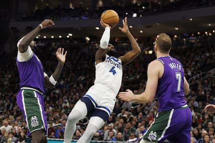 Dec 30, 2022; Milwaukee, Wisconsin, USA;  Minnesota Timberwolves guard Jaylen Nowell (4) shoots between Milwaukee Bucks forward Bobby Portis (9) and forward Joe Ingles (7) during the fourth quarter at Fiserv Forum. Mandatory Credit: Jeff Hanisch-USA TODAY Sports