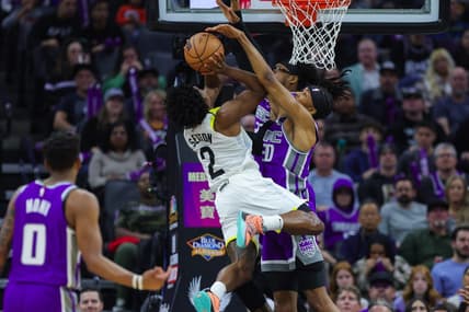 Dec 30, 2022; Sacramento, California, USA; Utah Jazz guard Collin Sexton (2) shoots the ball against Sacramento Kings forward KZ Okpala (30) and center Richaun Holmes (22) during the second quarter at Golden 1 Center. Mandatory Credit: Sergio Estrada-USA TODAY Sports