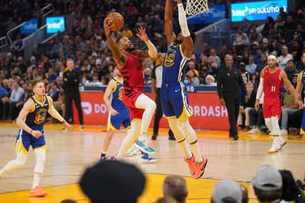 Dec 30, 2022; San Francisco, California, USA; Portland Trail Blazers guard Damian Lillard (0) makes a layup next to Golden State Warriors forward Jonathan Kuminga (00) in the second quarter at the Chase Center. Mandatory Credit: Cary Edmondson-USA TODAY Sports